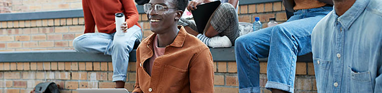 Students sitting outside on concrete and brick seating