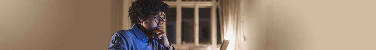 Man in blue shirt looking at computer